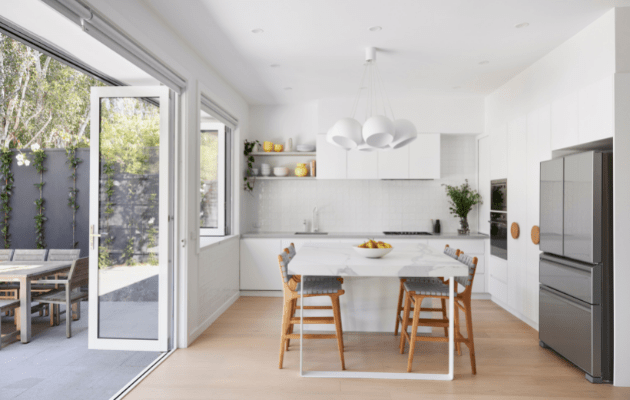 Smarter Bathrooms and Kitchens - a modern kitchen in Brunswick Home with teardrop lights, beautiful wooden floors, light filled kitchen built by kitchen renovations Melbourne specialist.
